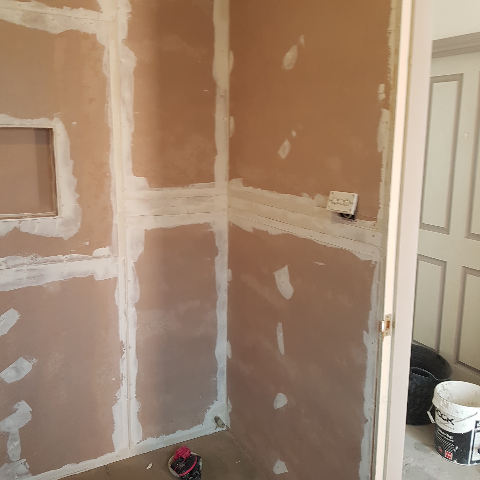New plasterboard walls with joints taped and a shower niche cut in
