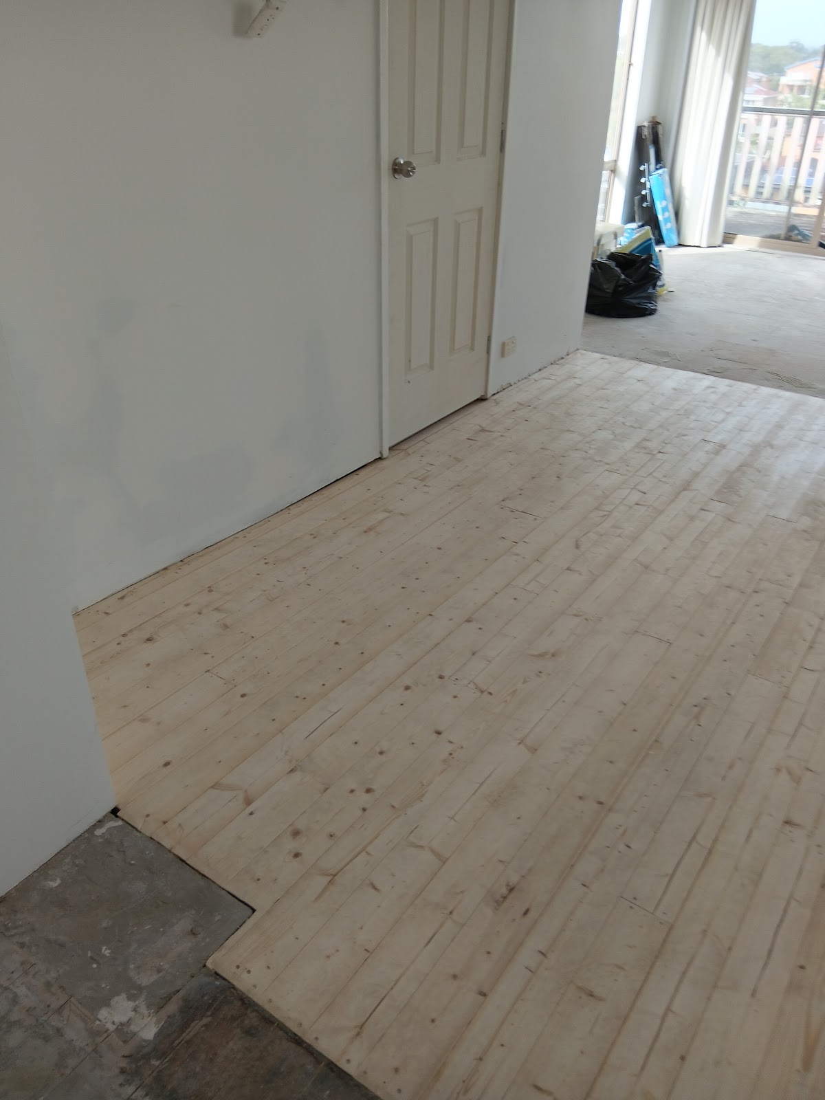 New pine floorboards laid through a hallway