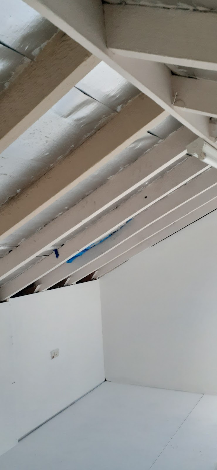 Plasterboard lining under a staircase